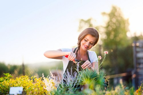 Landscapers working safely with tools and green waste
